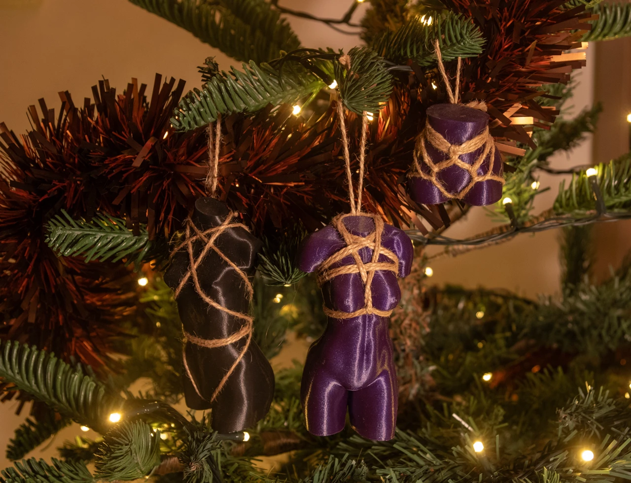 Three kinky ornaments on a christmas tree
